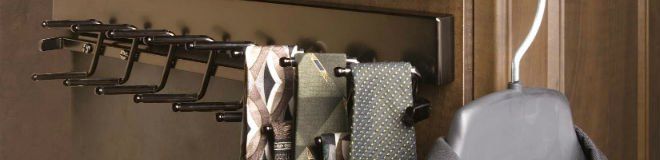 A bunch of towels are hanging on a rack on a wall.