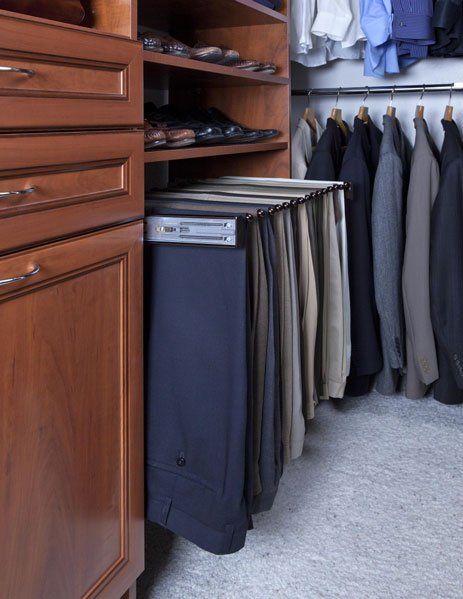 A closet filled with lots of pants and jackets