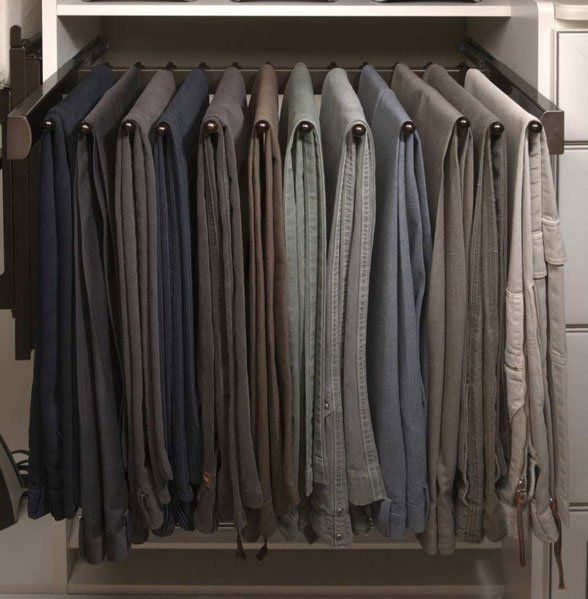 A closet filled with shirts and pants in different colors