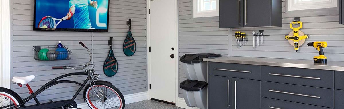 A bicycle is parked in a garage next to a television.