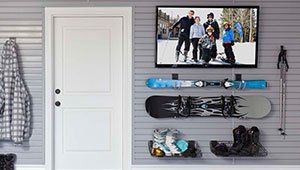 There is a picture of a family on the wall above the snowboards.