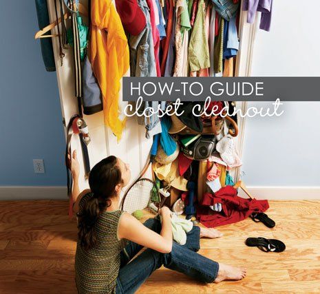A woman is sitting on the floor in front of a cluttered closet