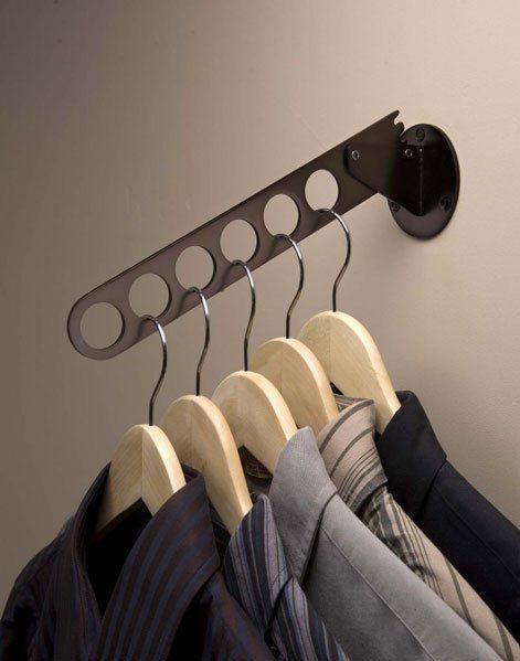 A row of shirts and ties hanging on a rack