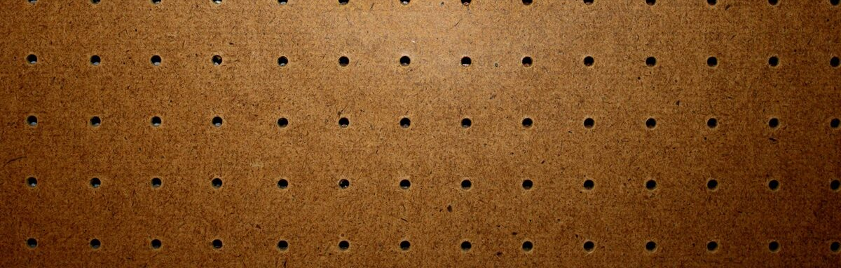A close up of a piece of wood with holes in it.