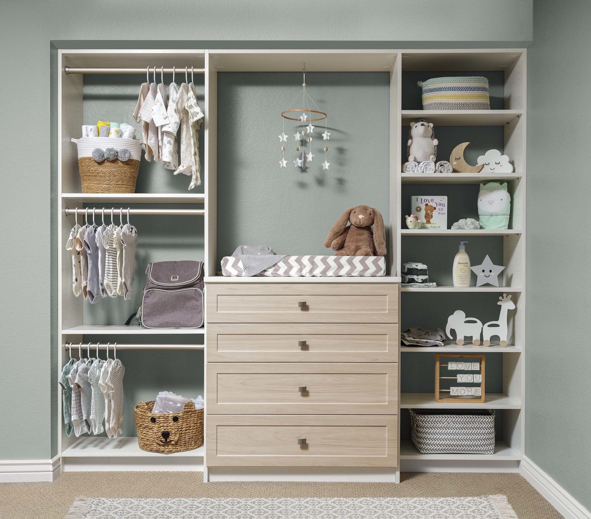 A baby room with a changing table and dresser