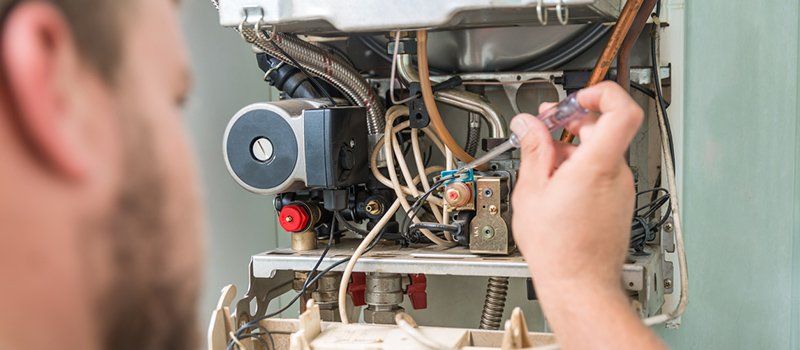 Heat Pump Repair — Man Fixing Heat Pump in Hickory, NC Heat Pump Repair — Man Fixing Heat Pump in Hickory, NC