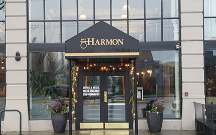 Top Quality Awnings — Brick Building With Striped Awning in Tacoma, WA Top Quality Awnings — Brick Building With Striped Awning in Tacoma, WA