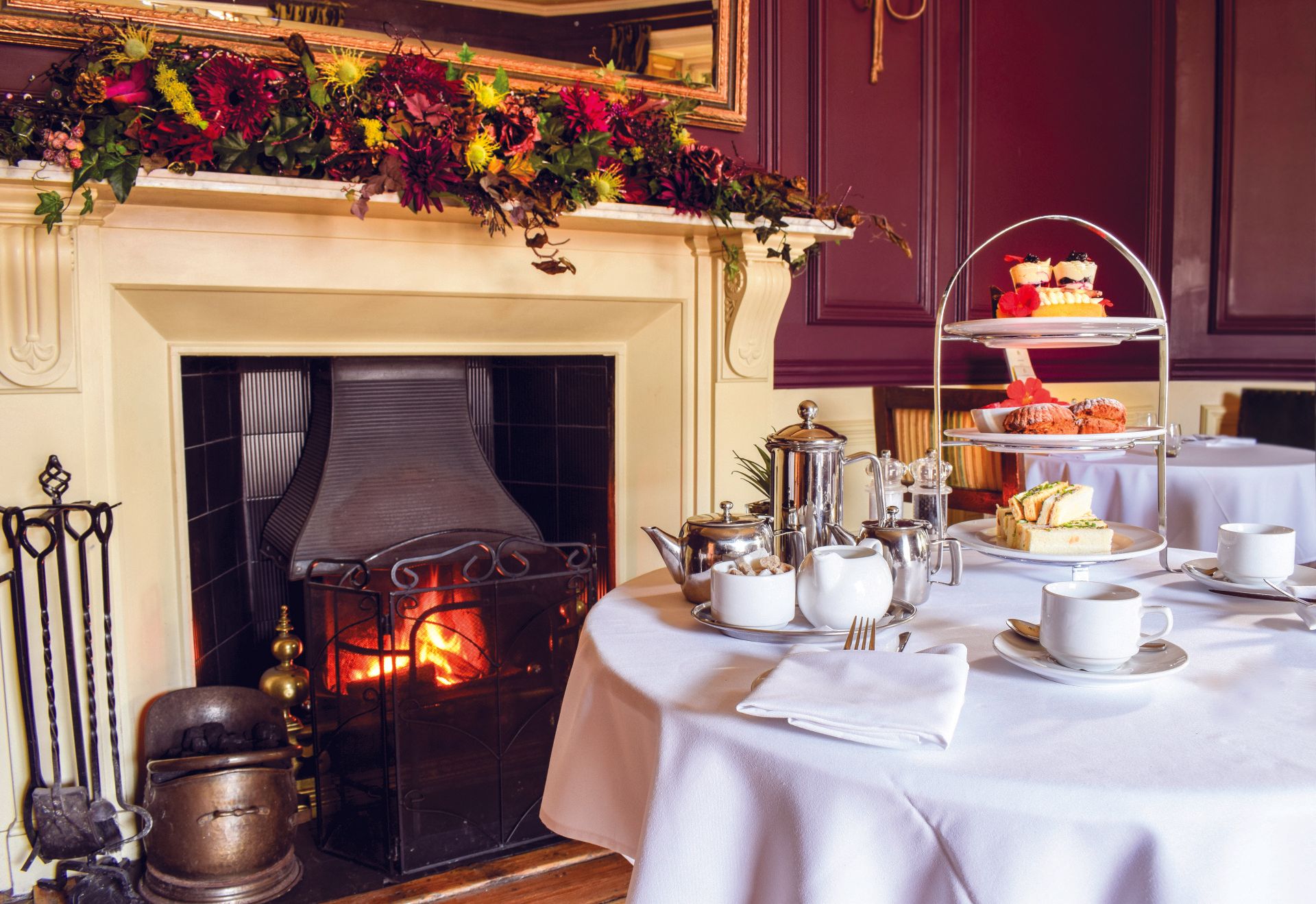 A table with a fireplace and a tray of food on it