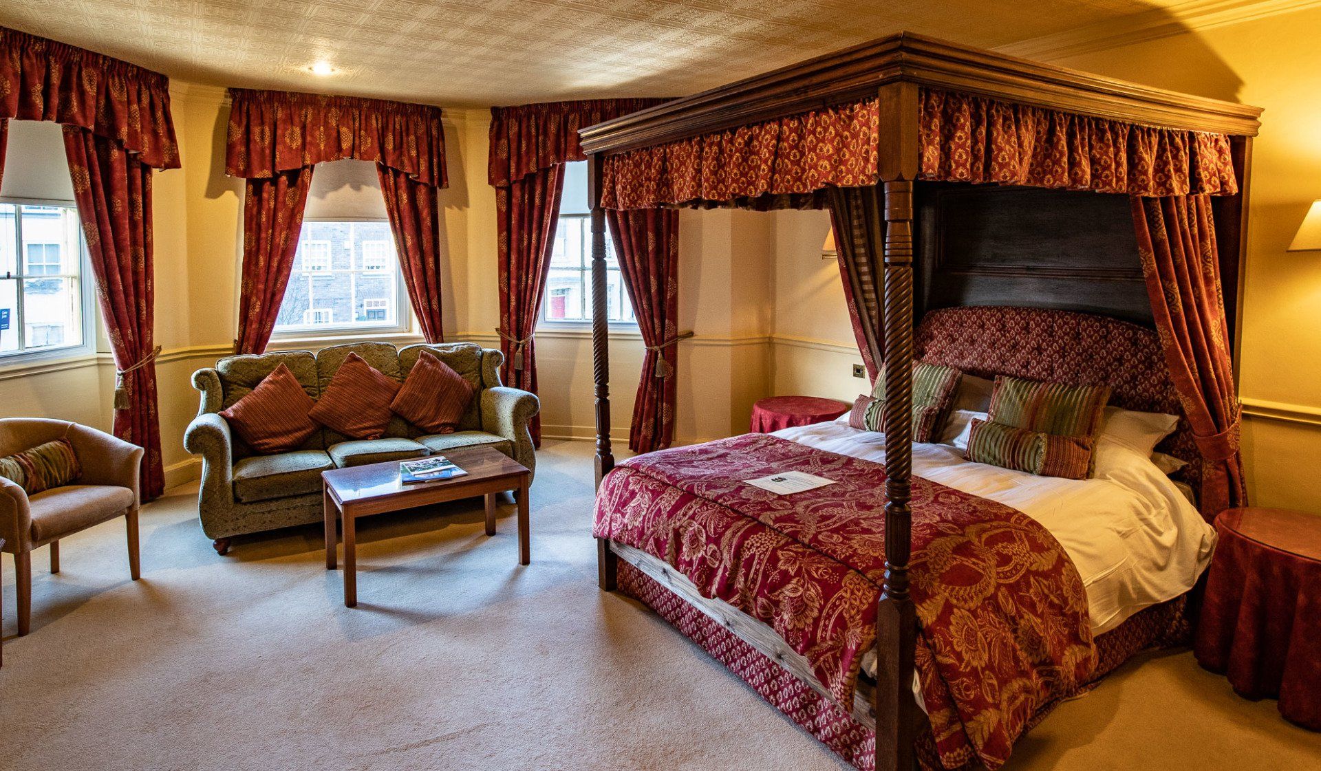 There is a four poster bed in the middle of the room.