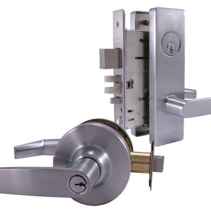 A stainless steel door lock with a key in it