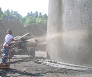 Man cleaning the cement wall — Concrete Construction Service in Lowell, MA
