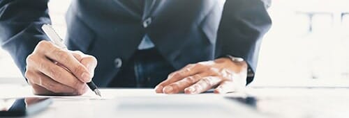 Businessman Signing Contract Making A Deal — Furniture Services in Statesville, NC