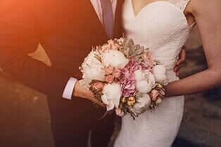 Couple holding a bouquet of flowers - Limousine Service in New Port Richey, FL