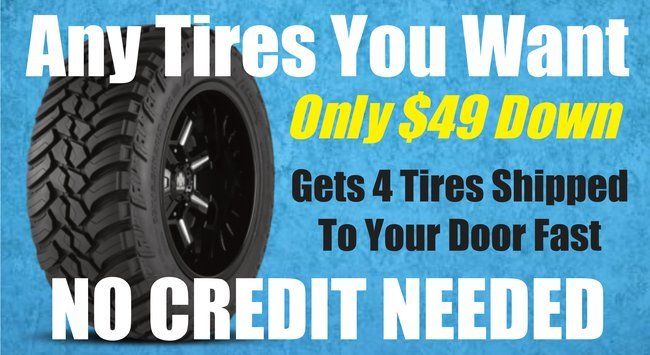 a sign that says any tires you want only $ 49 down gets 4 tires shipped to your door fast no credit needed