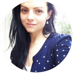 a woman in a blue and white polka dot sweater takes a selfie