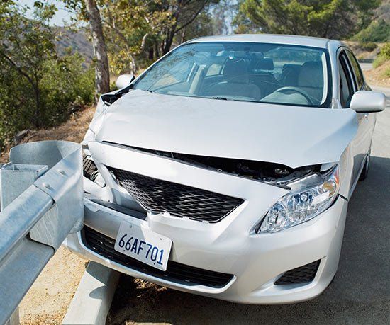 Silver car crashed into guardrail.

