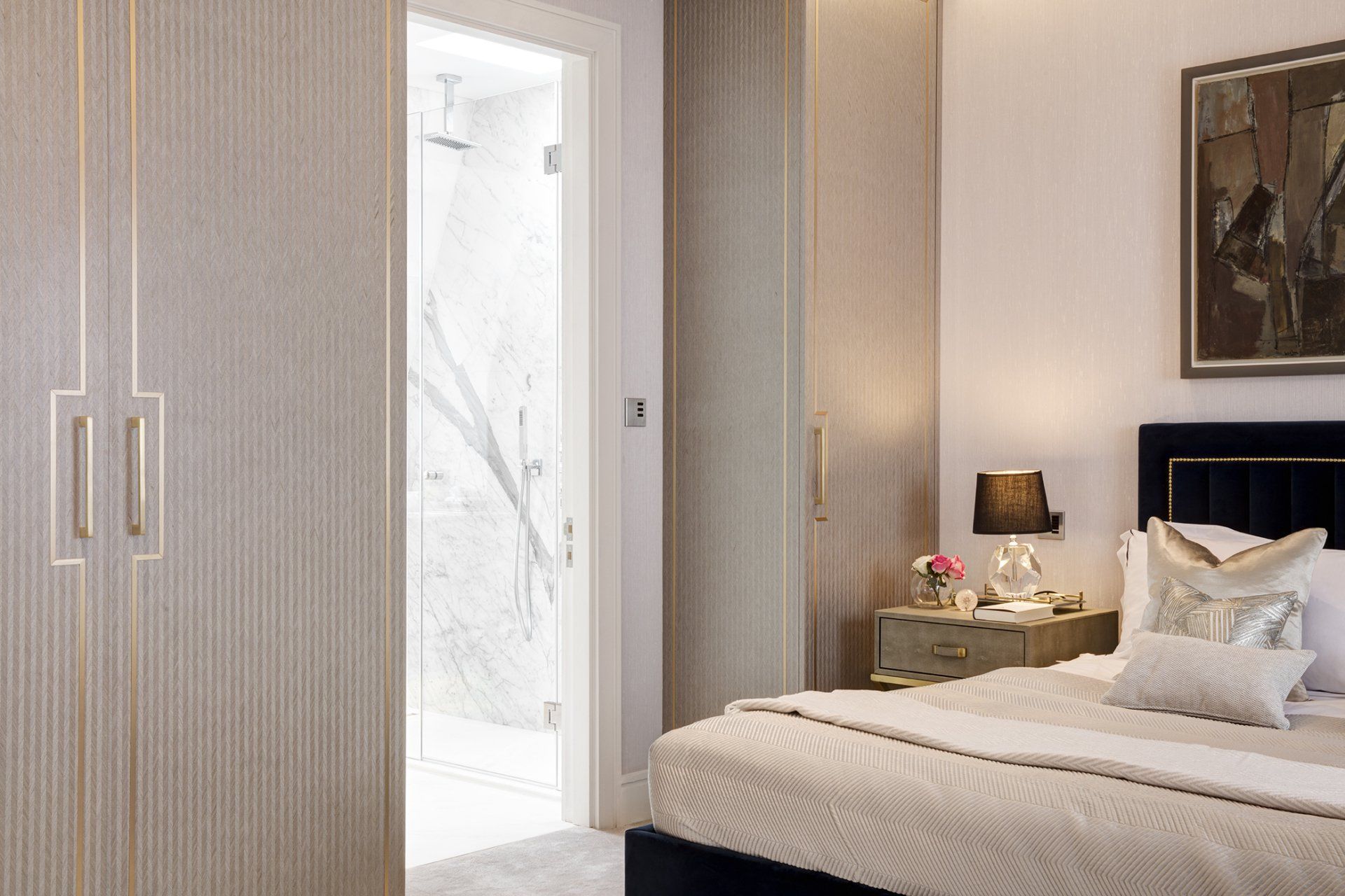 A bedroom with a large bed and a painting on the wall