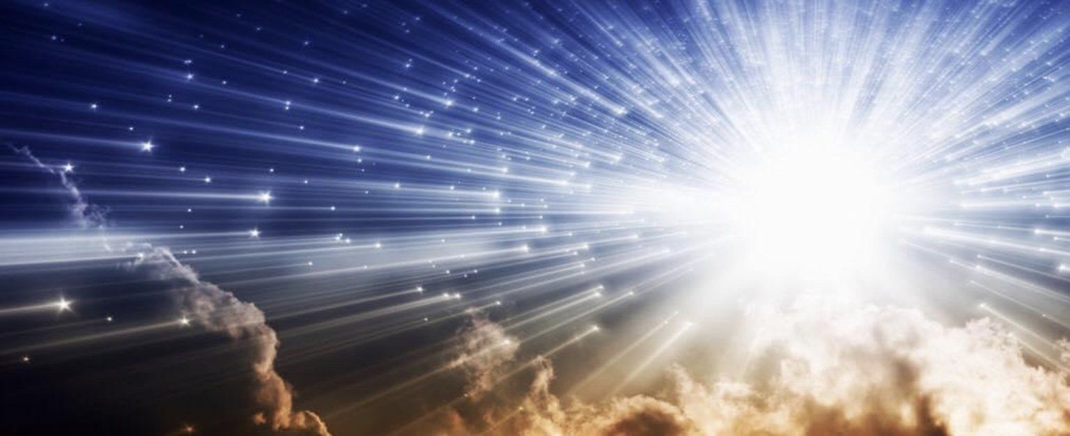 Bright light bursts from the center of a sky filled with stars and clouds.