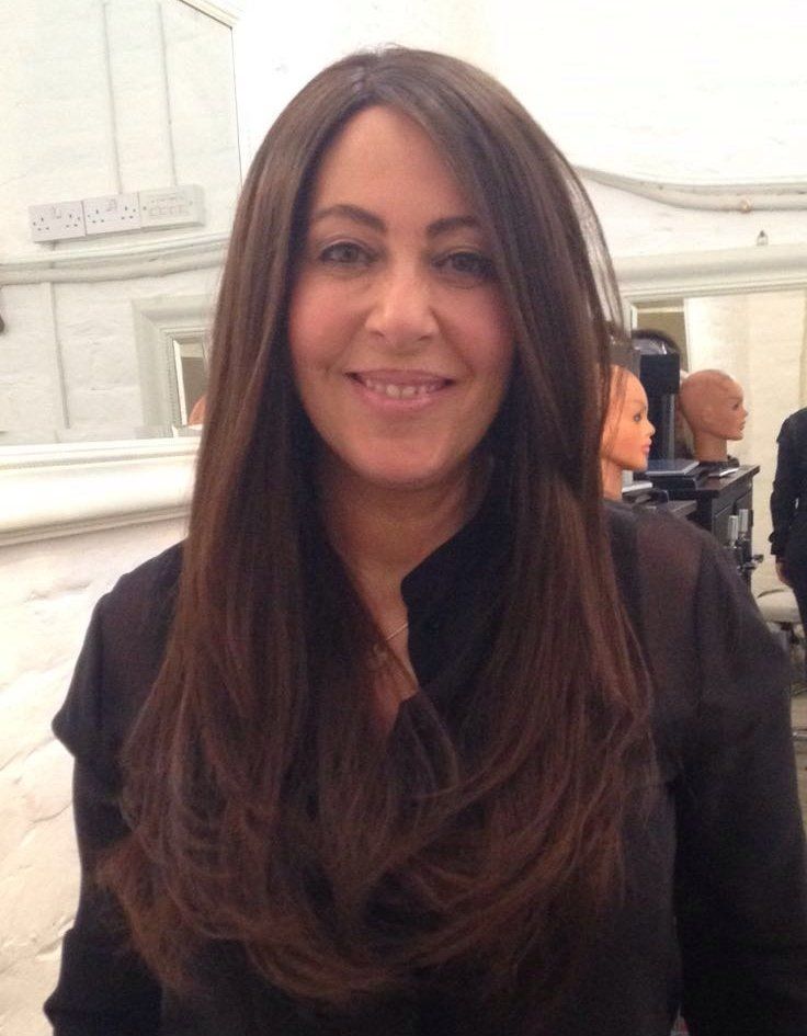 Photo of a happy woman with a long dark brown hair wig