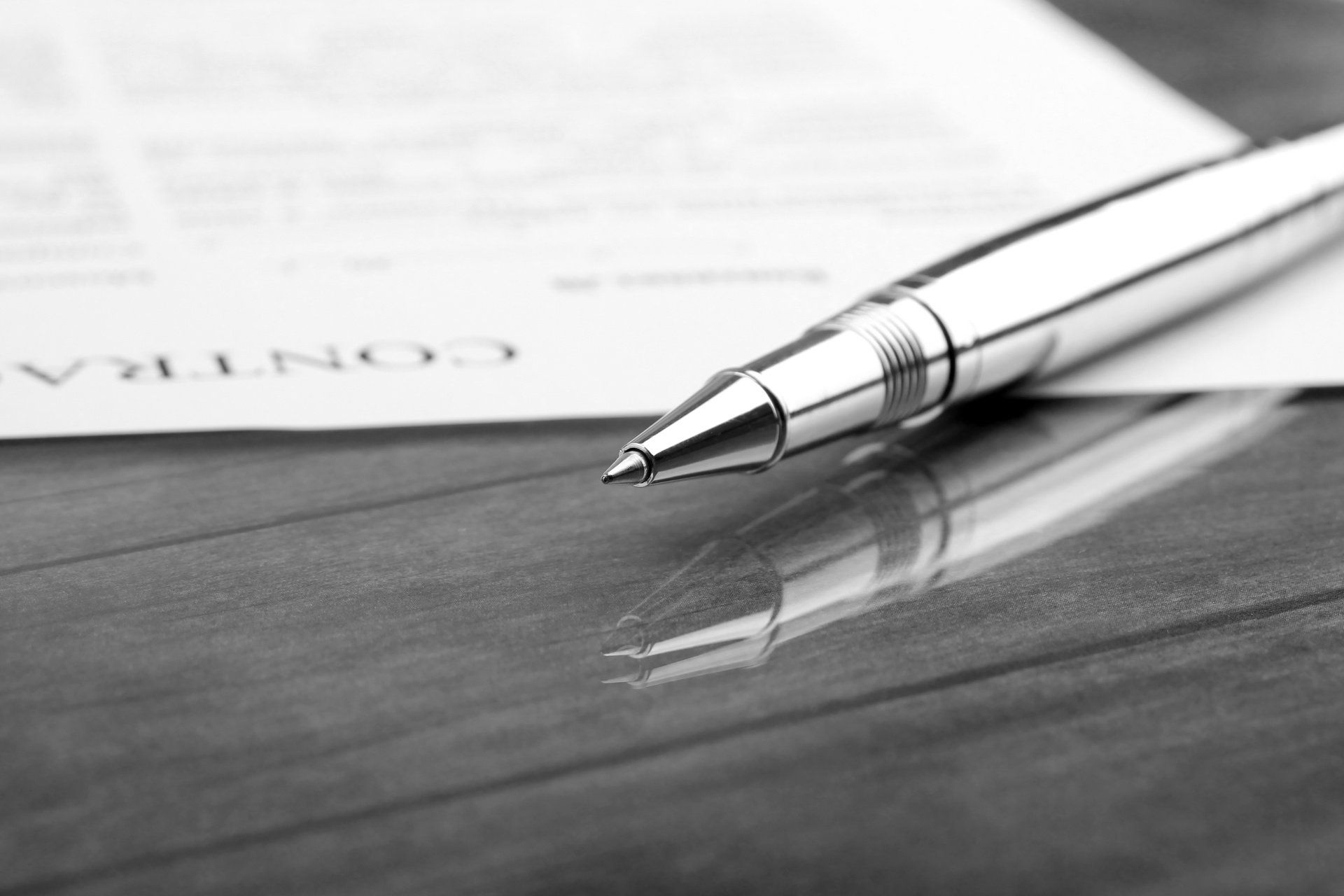 A pen is sitting on top of a piece of paper that says contra