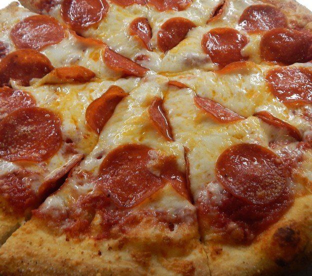 A pepperoni pizza with cheese and pepperoni on it