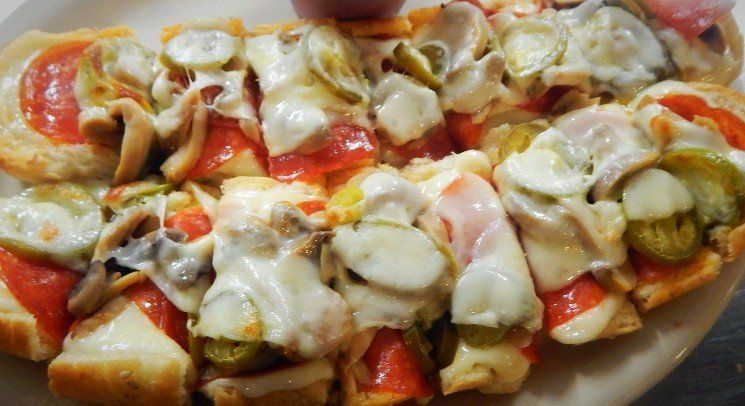 A white plate topped with a variety of vegetables and cheese.