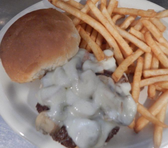 A white plate topped with a hamburger and french fries