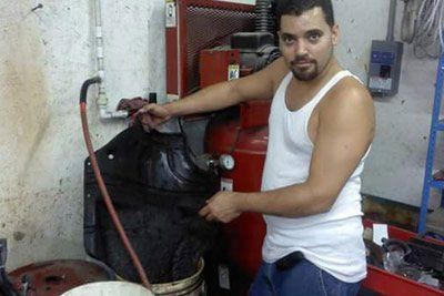 Car A/C Service — Workers Repairing Car Part in Orange Park, FL Car A/C Service — Workers Repairing Car Part in Orange Park, FL