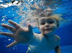 child swimming in pool