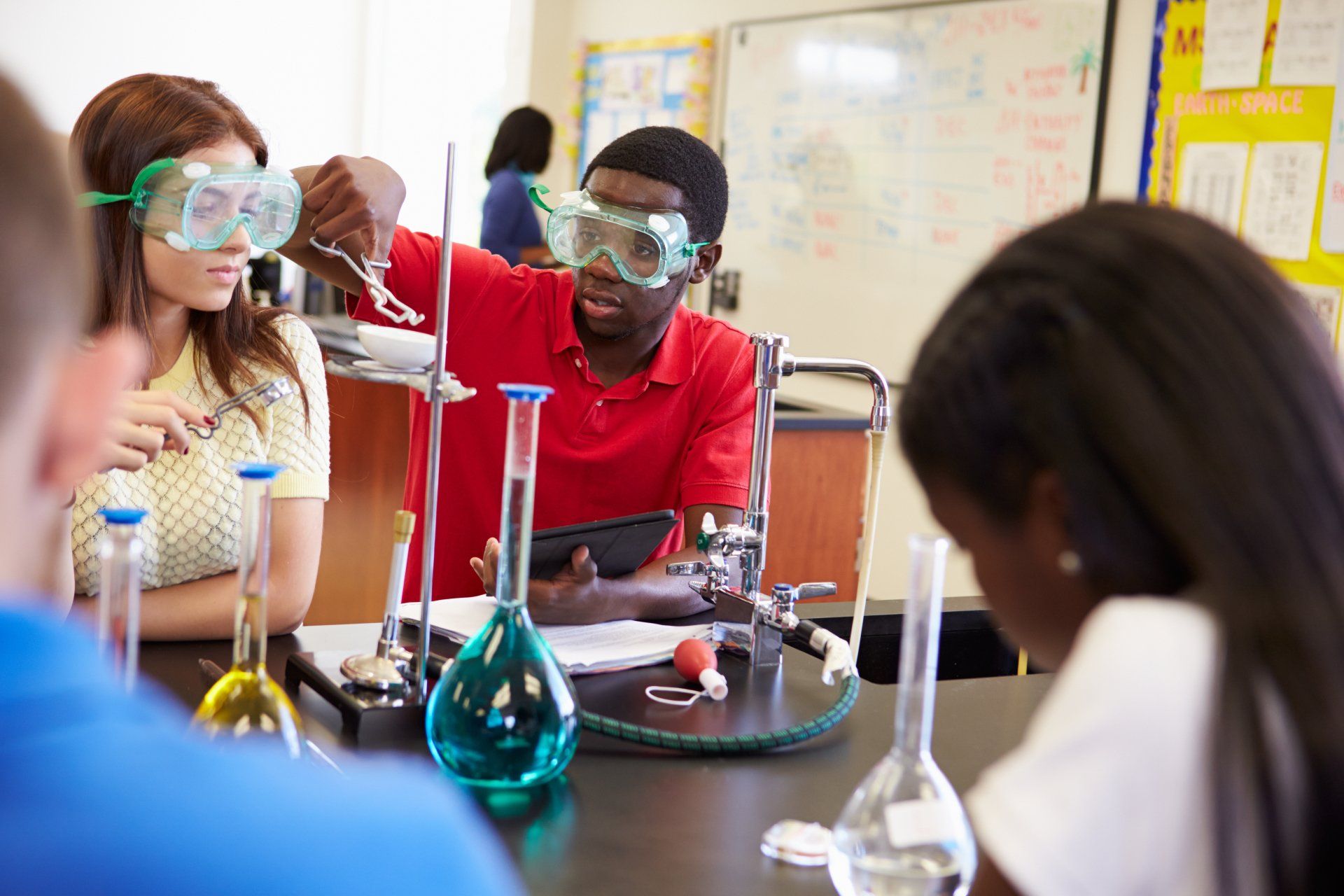 A group of students are doing a science experiment in a classroom.