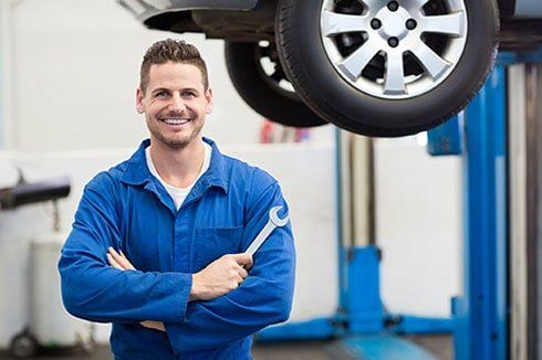 Mechanic Holding a Wrench - Auto Repair and Maintenance Services in Charlottesville, VA