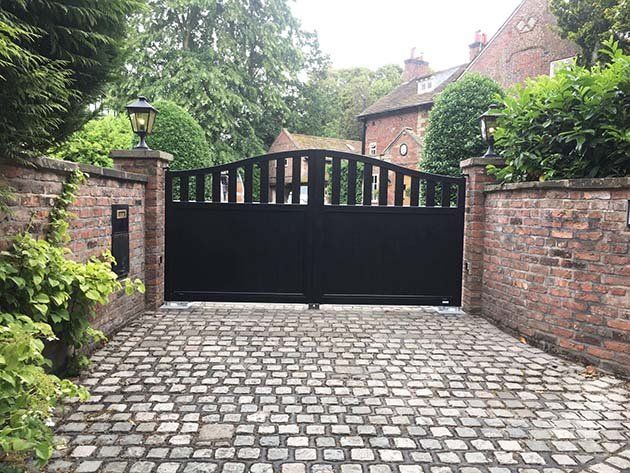wooden gates at the entrance to a driveway