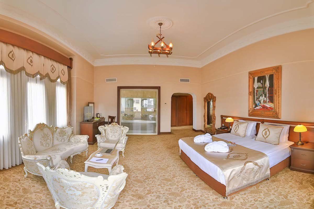 A hotel room with a large bed and a couch