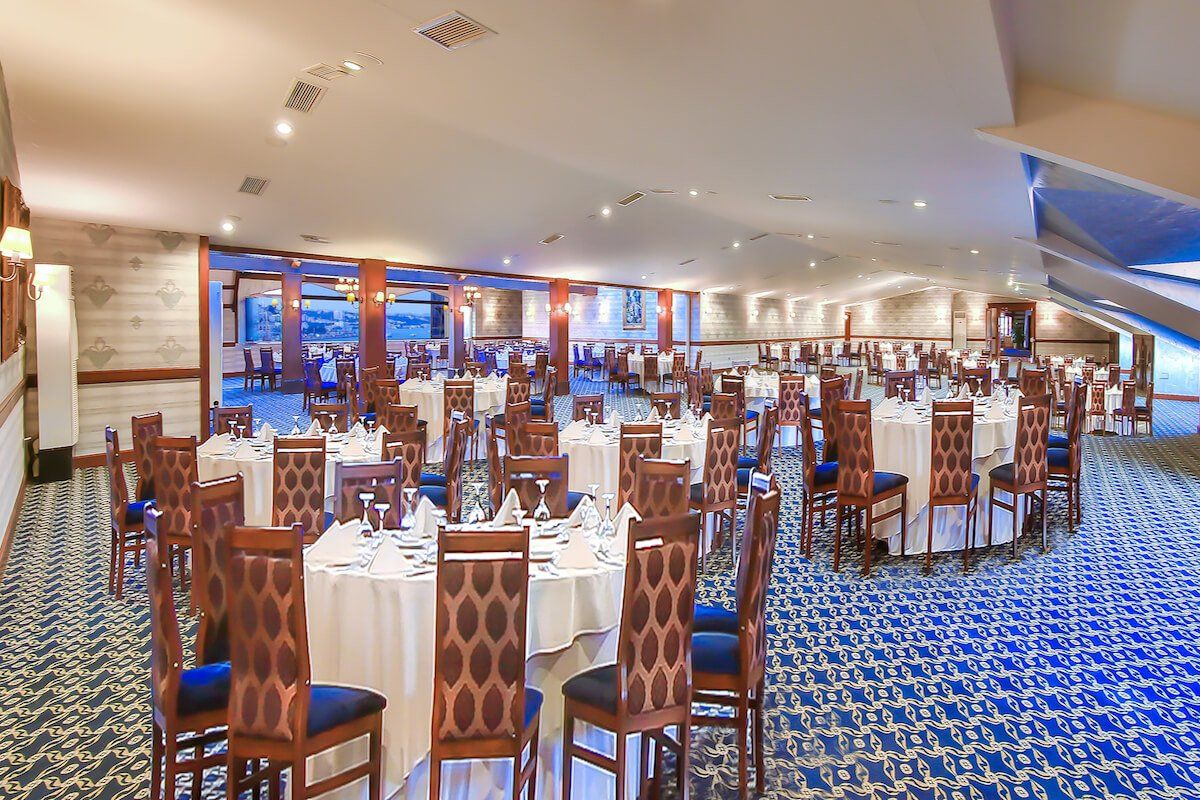 A large room with tables and chairs set up for a banquet.