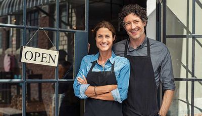 Insured Employees — Couple Business Owners Outside Store in Milwaukee, WI