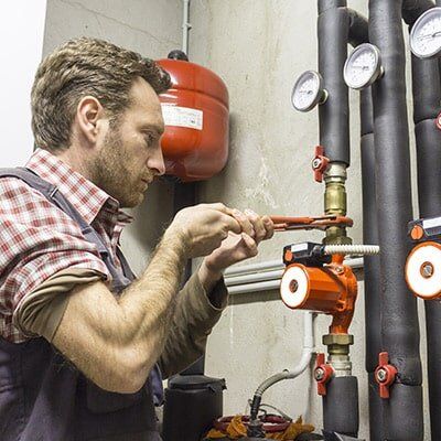man fixing water pipe — Hipwell Plumbing in Tweed Heads, NSW man fixing water pipe — Hipwell Plumbing in Tweed Heads, NSW