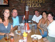 beer keg at our pizza restaurant People around table with personal draft beer tower