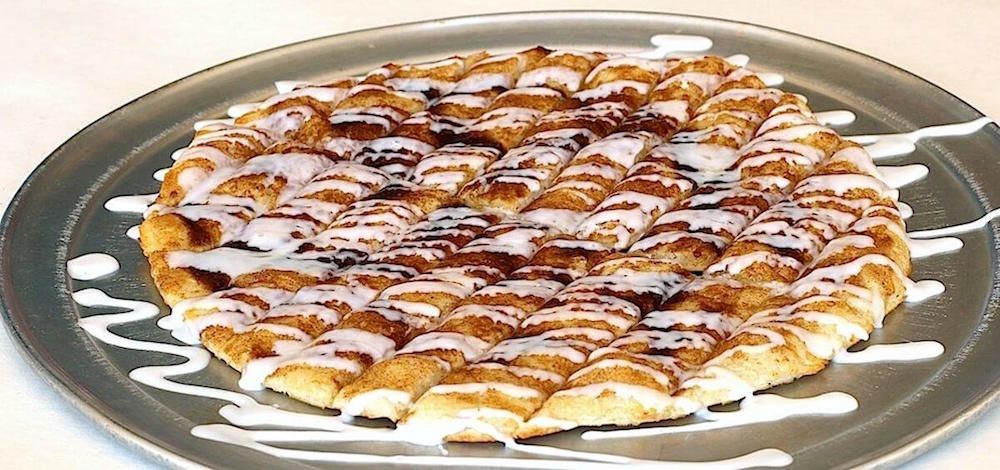Family Friendly Pizza Restaurant Cinnamon Pizza Dessert with Icing Drizzled on Top