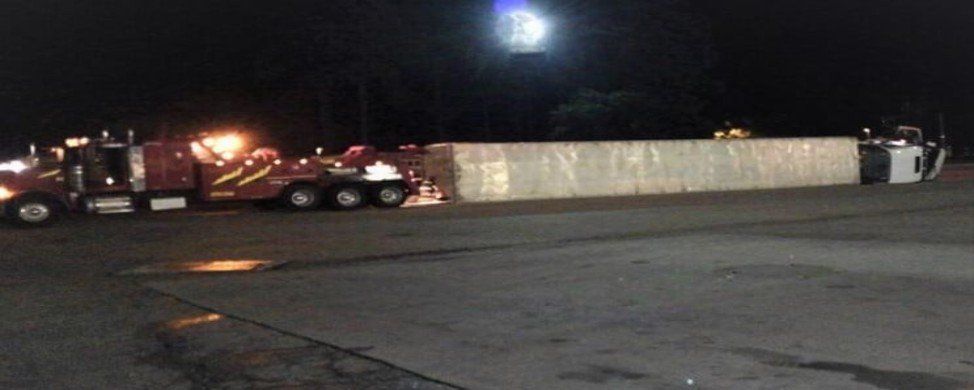 Red tow truck at night - towing in Tallahassee FL