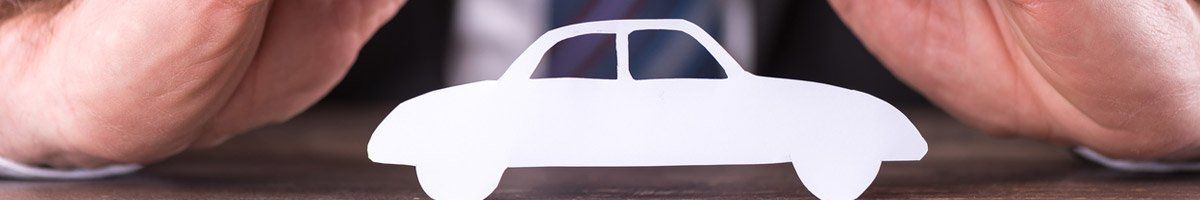 hands shielding paper car cut-out
