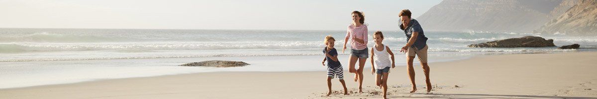 family running on beach happily