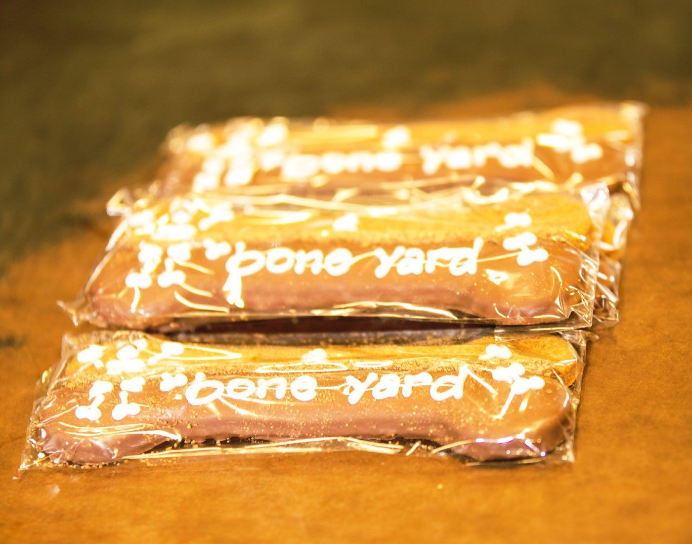 Two orange wrapped bonе-yard snacks stacked on a warm-toned surface
