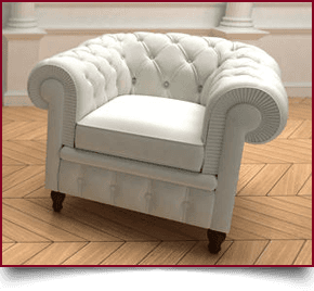 Red leather sofa in front of black floral wallpaper