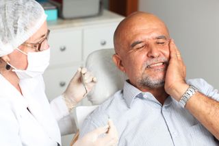 Cracked Tooth— Old Man Holding His Cheeks in Lexington, NE Cracked Tooth— Old Man Holding His Cheeks in Lexington, NE
