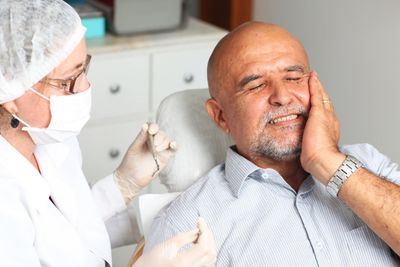 Cracked Tooth— Old Man Holding His Cheeks in Lexington, NE Cracked Tooth— Old Man Holding His Cheeks in Lexington, NE