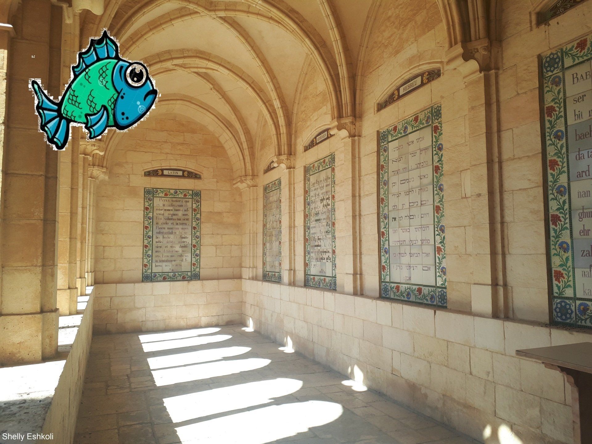 A cartoon fish floats in an arched stone corridor with decorative tiled panels.