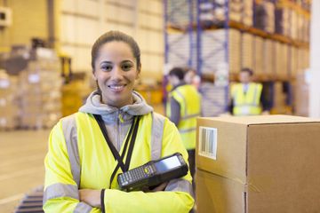 warehouse worker holding box scanner