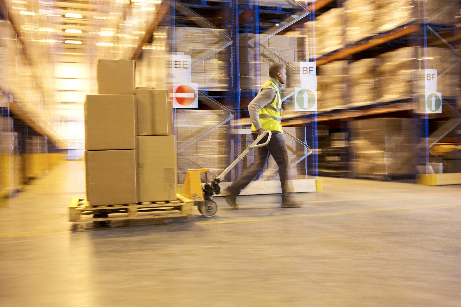 Pallet of parcels being pulled though a warehouse