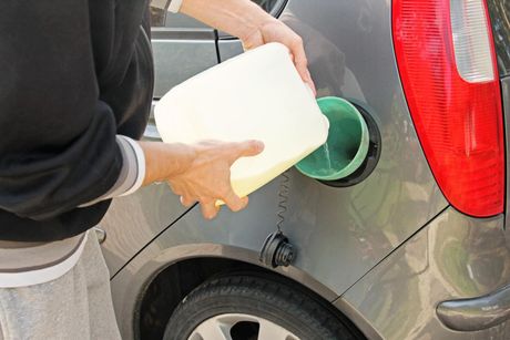 someone pouring gas on the car