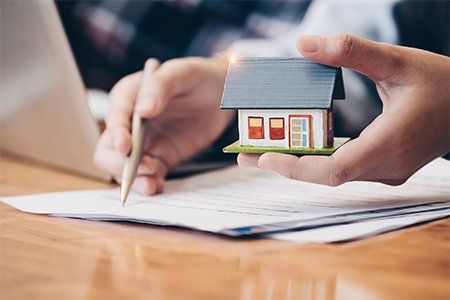 Close Up Real Estate Agent With House Model — Boynton Beach, FL — Insurance World Close Up Real Estate Agent With House Model — Boynton Beach, FL — Insurance World